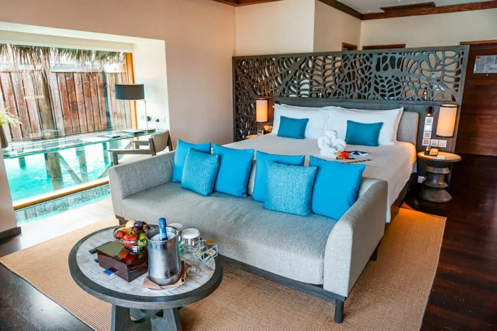 Living and sleeping space of Sunrise Water Villa at Conrad Maldives Rangali Island.