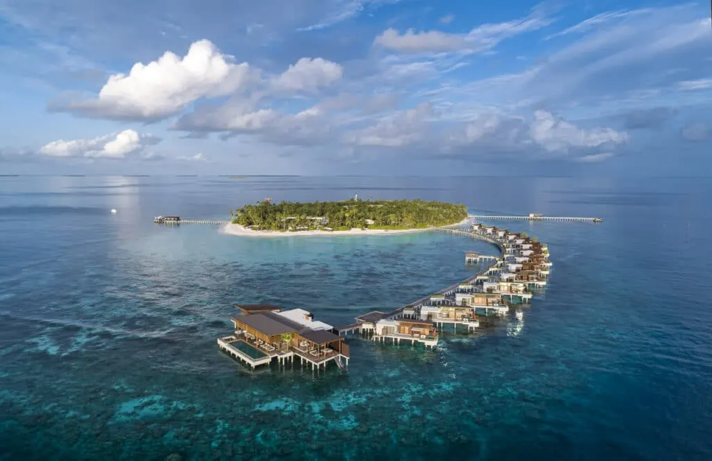 Park Hyatt Maldives Hadahaa overwater villas in the deep blue Indian Ocean.