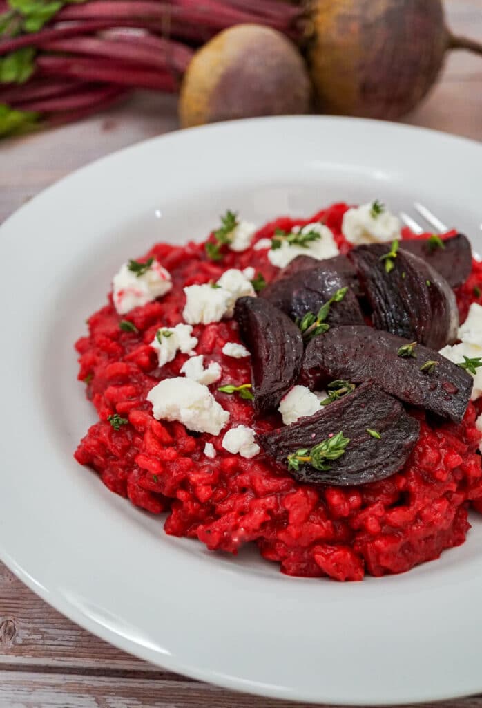 Roasted beets on a bed of red risotto with crumbled goat cheese and thyme on top. 
