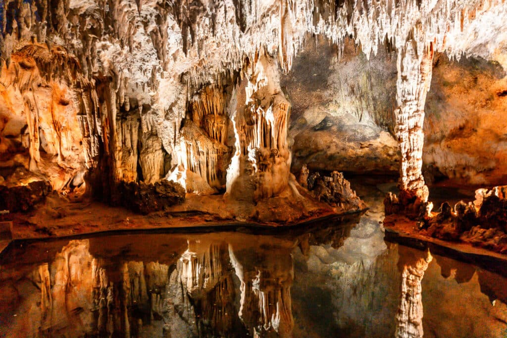 The Cave of Wonders and its reflection from still water.