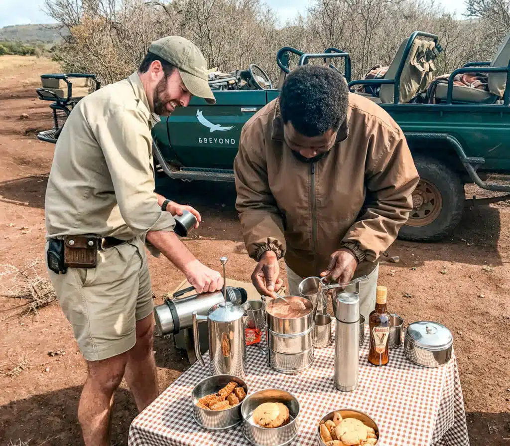 A ranger and tracker preparing a snack break of coffee and cookies from AndBeyond Phinda Mountain Lodge.