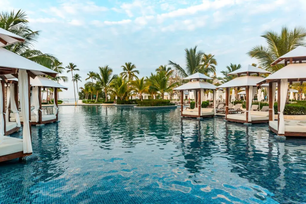 The main pool at Hilton La Romana with white cabana beds.