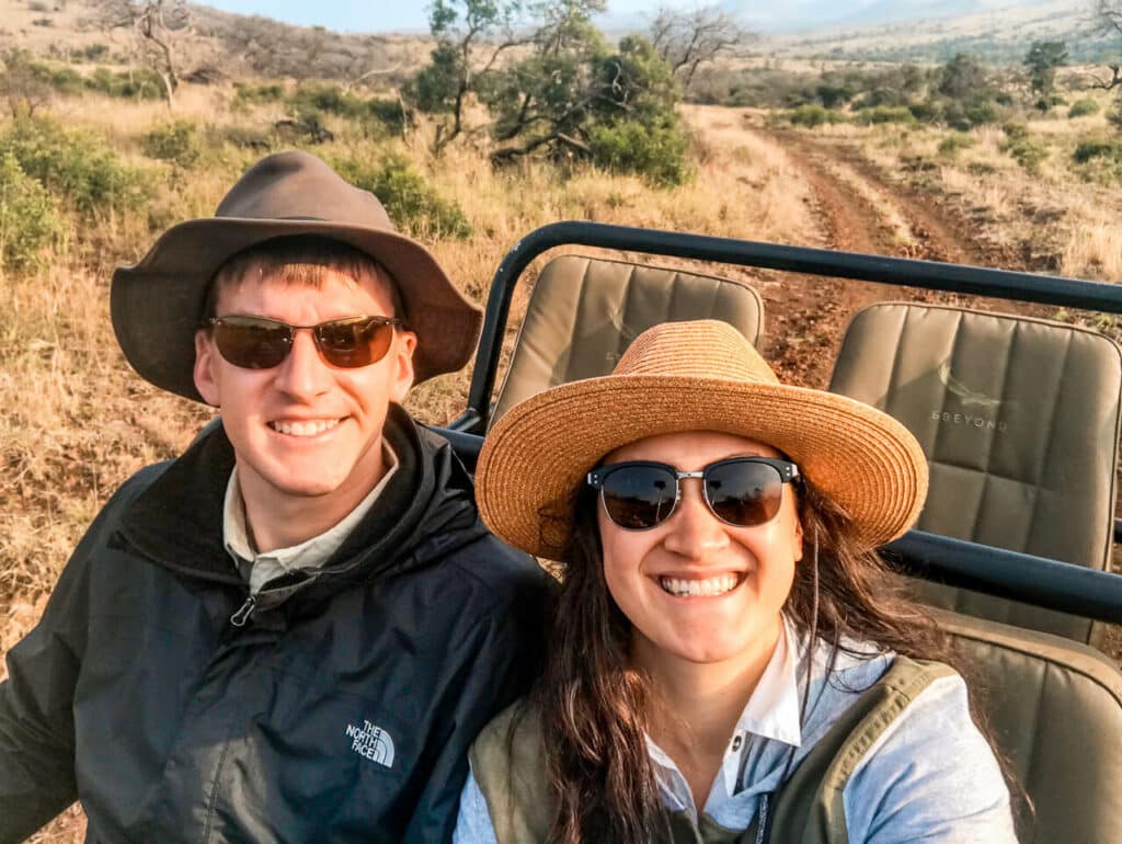 A couple taking a selfie on their game drive at Phinda Private Game Reserve.