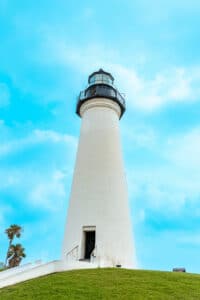 Port Isabel Lighthouse, a white historic lighthouse in South Texas on top of a grassy hill.