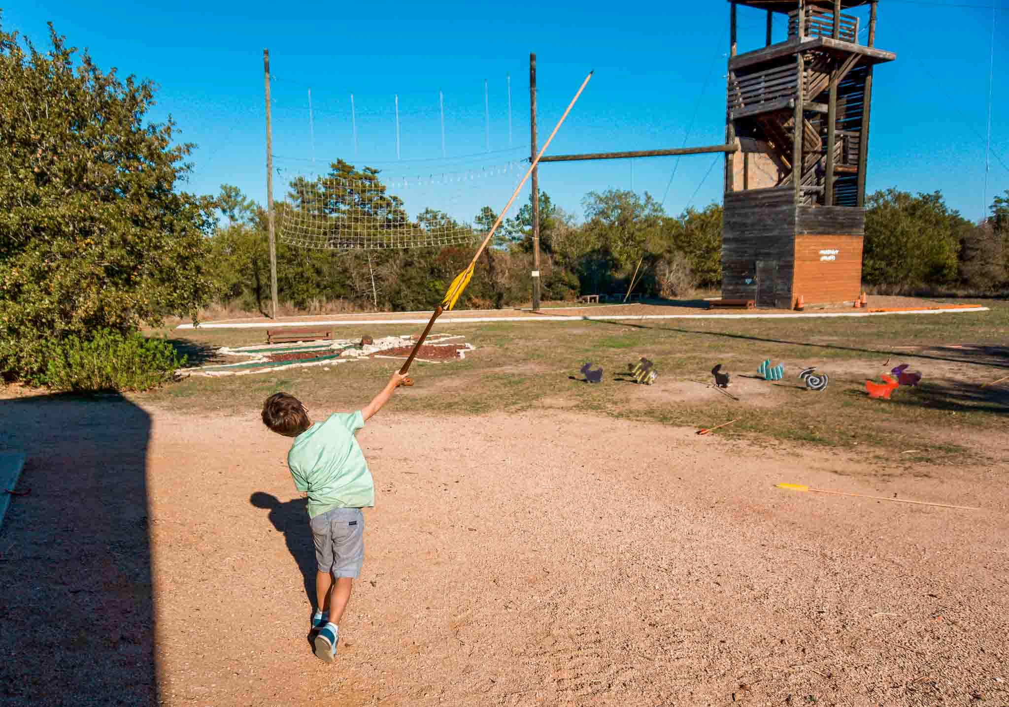 A young boy throwing a javelin at one of the LCRA Parks, McKinney Roughs Nature Park.