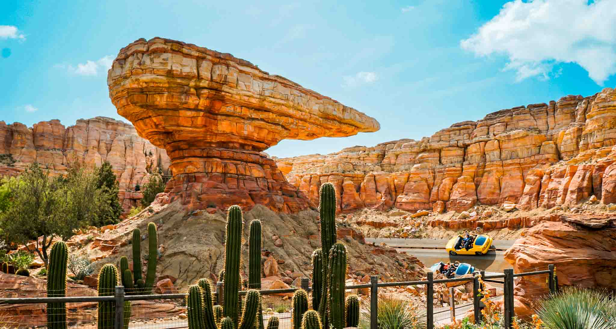 People riding the cars on a turn on the Radiator Springs ride at Disney California Adventure.