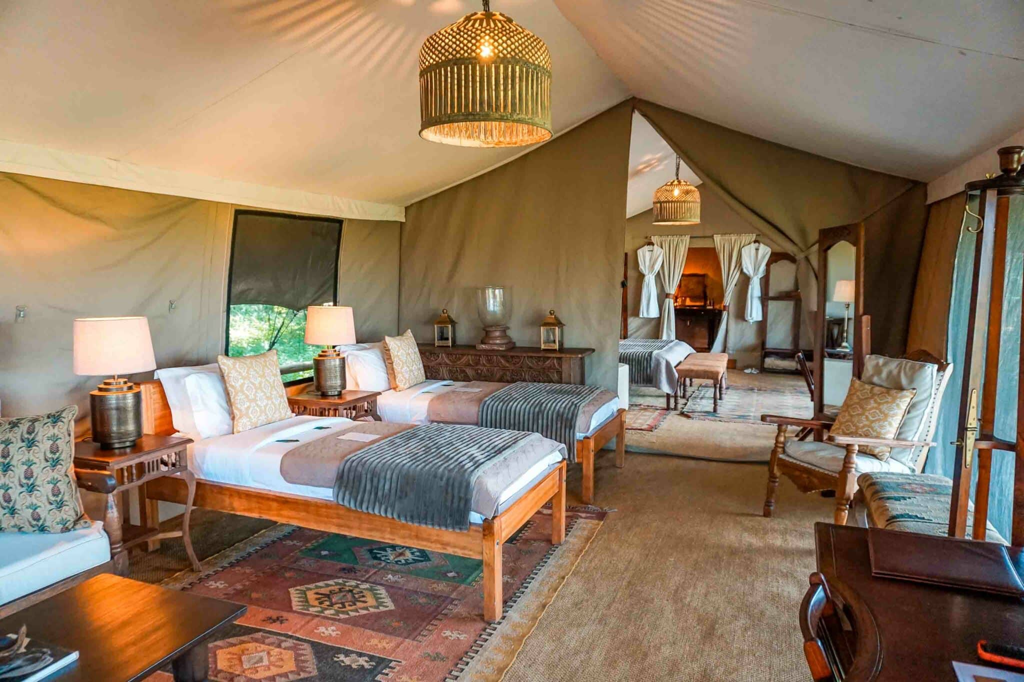 Two single beds in one room next to a second room inside the family suite at Elewana Elephant Pepper Camp.